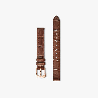 A brown crocodile-embossed leather watch strap shown in two pieces against a light gray background, featuring a rose gold buckle and matching rose gold tip.