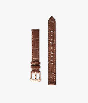 A brown crocodile-embossed leather watch strap shown in two pieces against a light gray background, featuring a rose gold buckle and matching rose gold tip.